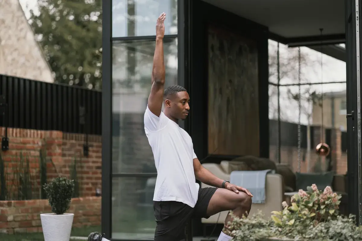 A kneeling stretch outdoors after training
