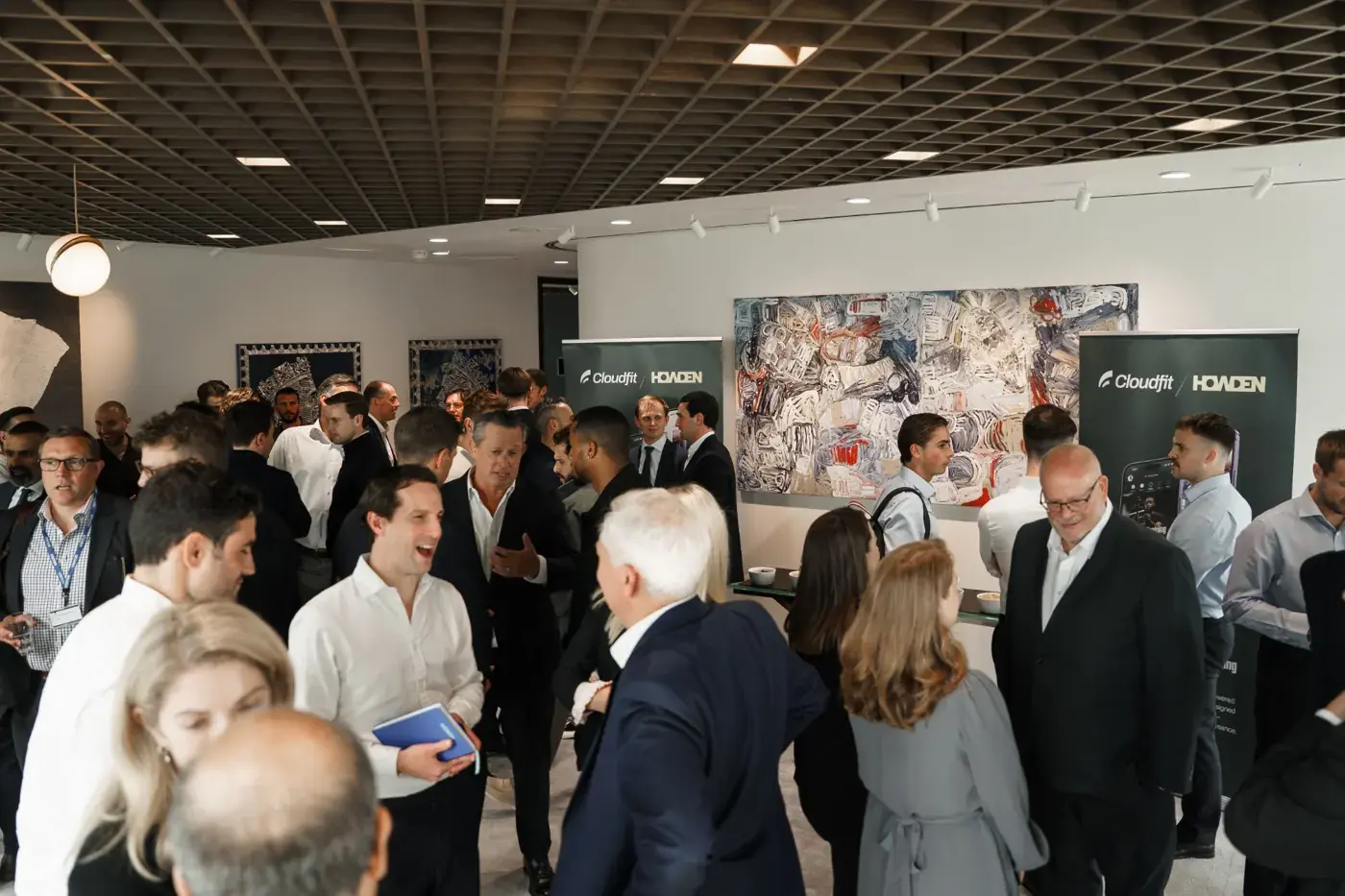 Guests talking beside CloudFit and Howden banners